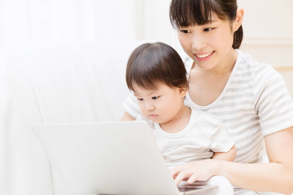 asian baby and mother using laptop